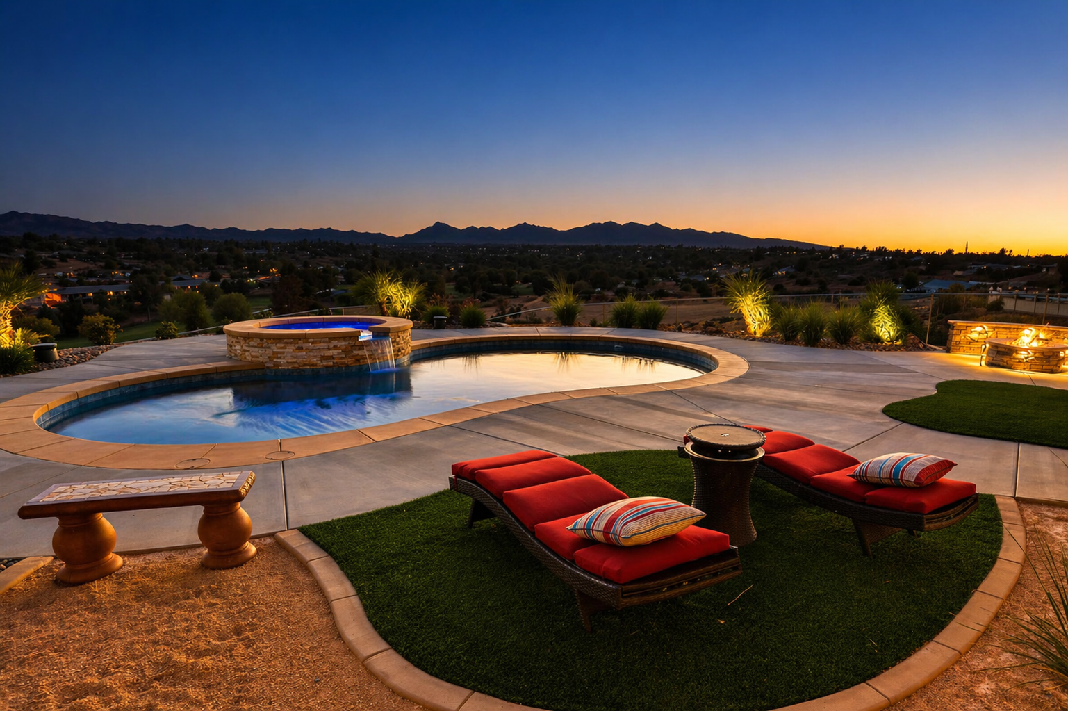 Freeform pool and spa with waterfall, fire pit, and mountain sunset view